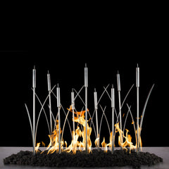 The Outdoor Plus Cat Tail Fireplace Burner Stainless Steel with Yellow Flame and Rock Media in Black Background