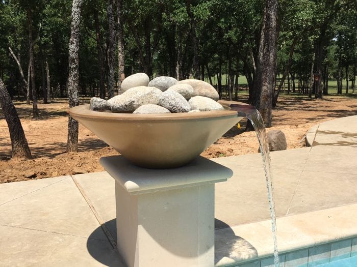 The Outdoor Plus Cazo Fire and Water Bowl NO Fire and lot of Big Stone in the Pool Area