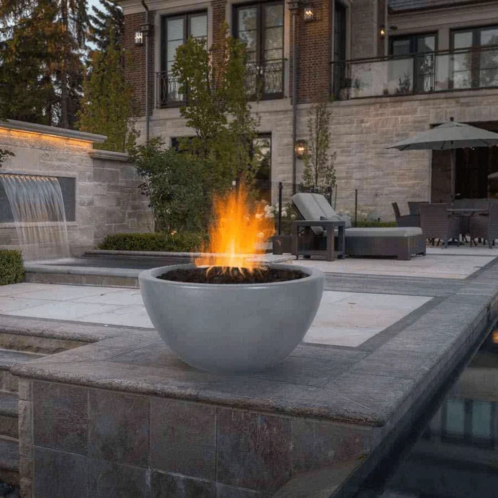The Outdoor Plus Luna GFRC Fire Bowl Grey Finish in the Pool Area