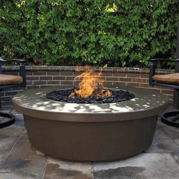 The Outdoor Plus Chocolate Tempe Concrete Fire Pit with Yellow Fire and Rock Media in Outdoor View