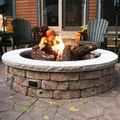 Warming Trends Circular Ready to Finish Fire Pit with Stone Table with Backyard View and Chair