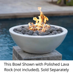 The Outdoor Plus Sedona GFRC Fire Bowl with Yellow Flame and Polished Lava Rock in Pool Area