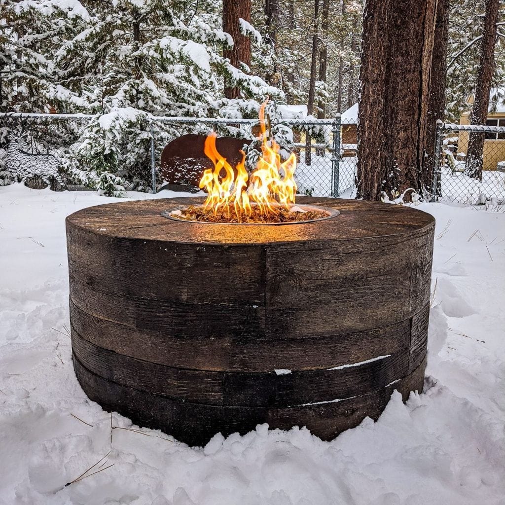 The Outdoor Plus Sequoia Wood Grain Fire Pit with Yellow Flame in Winter Season