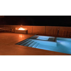 The Outdoor Plus Cabo Fire Pit Night View with Pool in Right