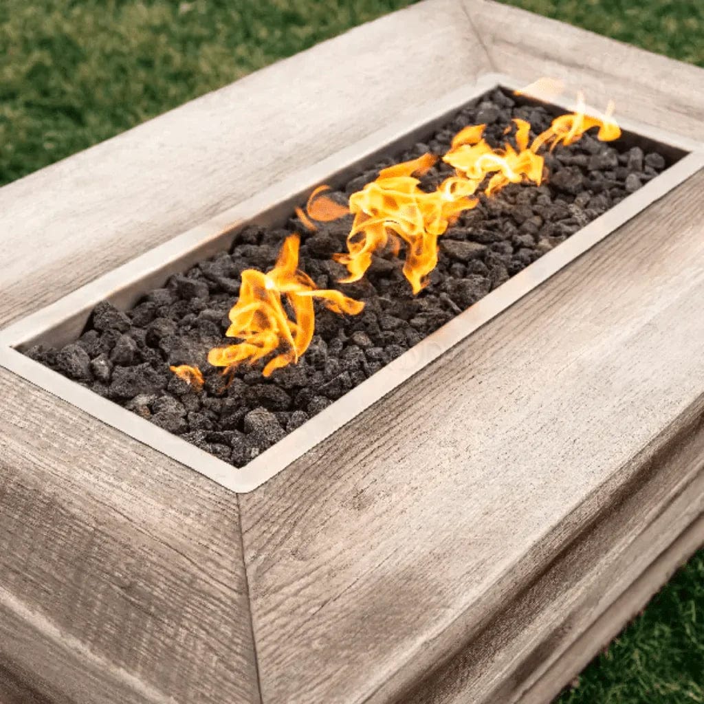 The Outdoor Plus Plymouth Wood Grain Fire Pit with Yellow Flame in the Grass