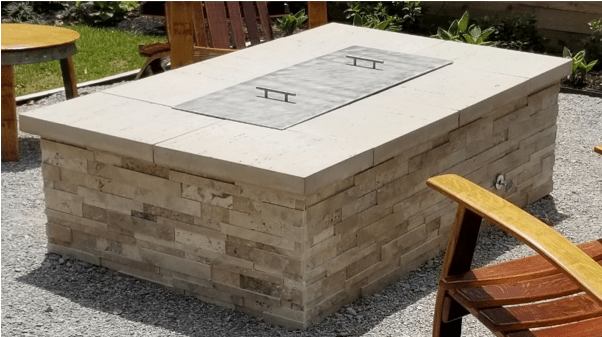Rectangular fire pit cover aluminum with 2 handles on finished fire pit with brick enclosure